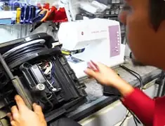 Vacuum repair technician servicing internal components on a workbench in Kansas City, MO